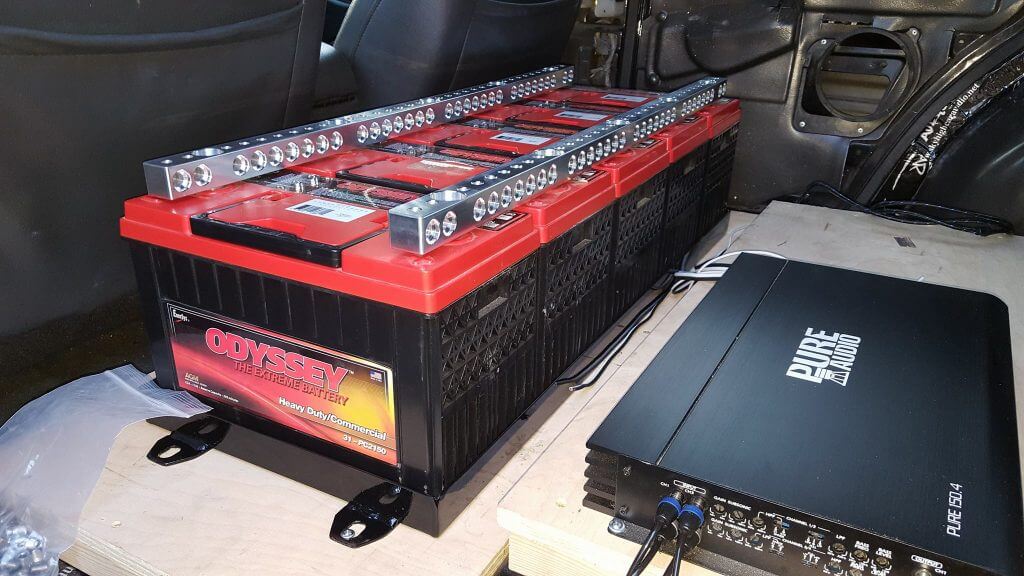 Competition amplifier rack and battery bank wiring in a car audio build